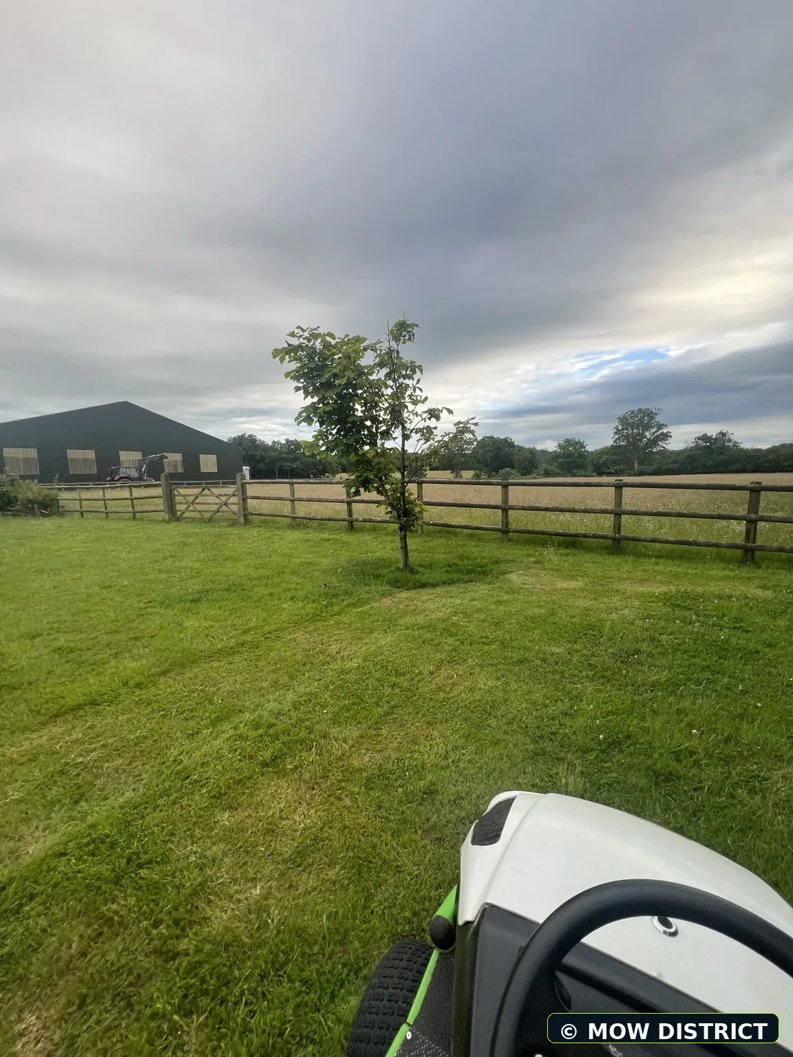 Ride-on mower in use on a large lawn